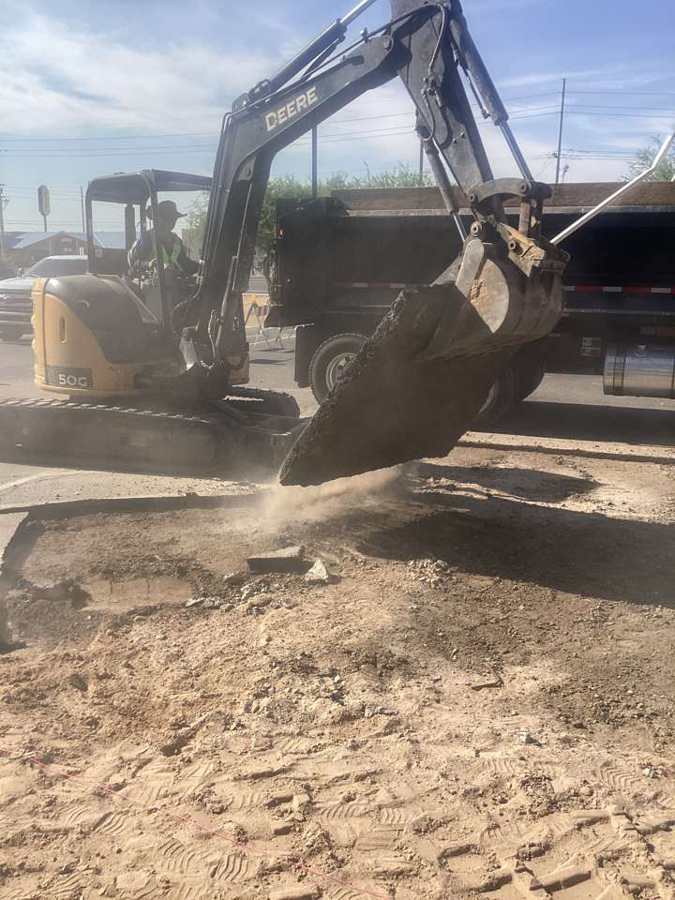 Lifting a slab of asphalt into the dump truck