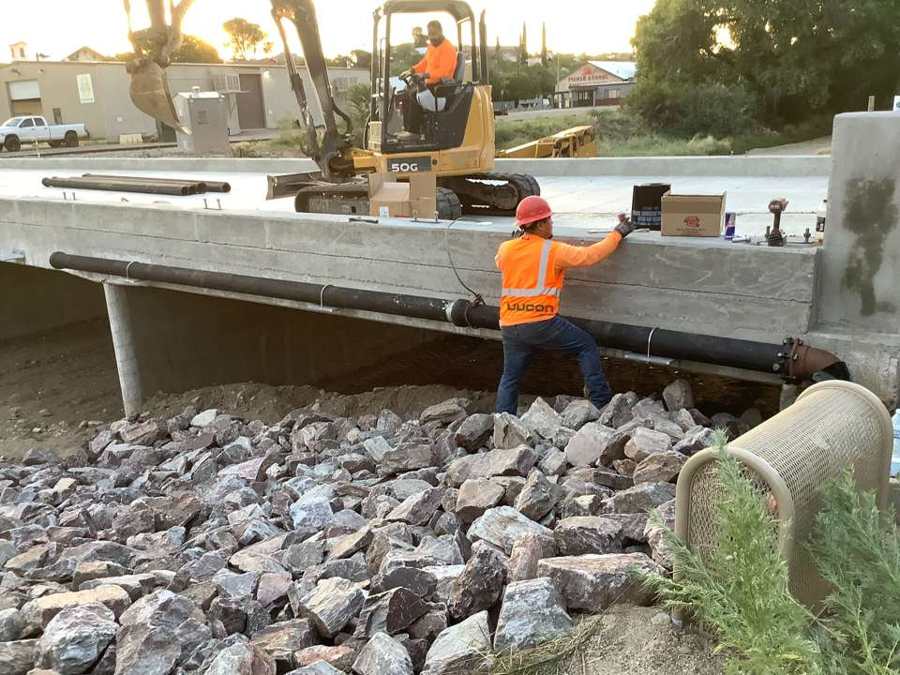 Ductile iron water line hung under a new bridge deck