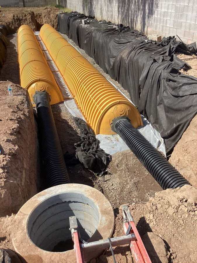 Retention chambers tied to a drywell