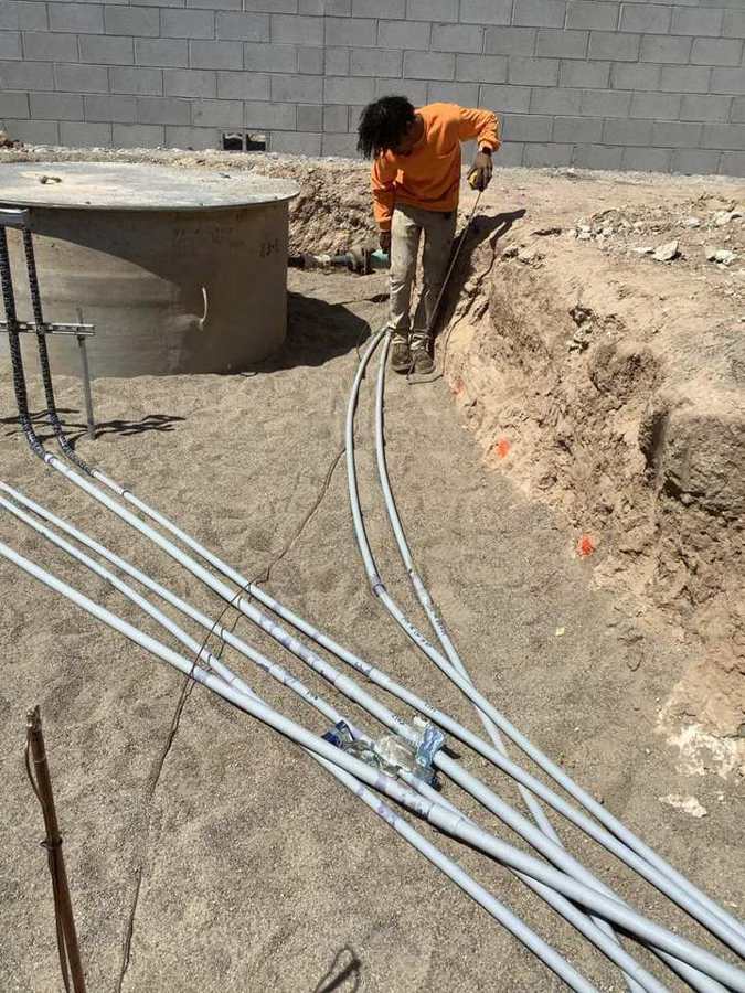 Crew trenching around a new lift station wet well