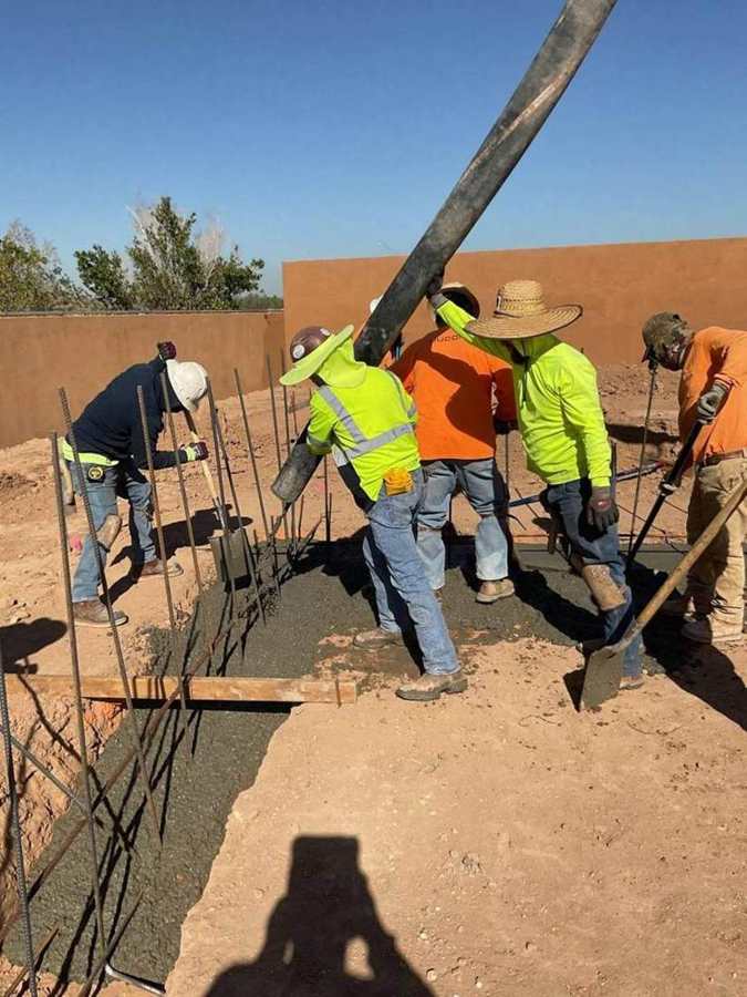 Crew placing concrete from the pump hose