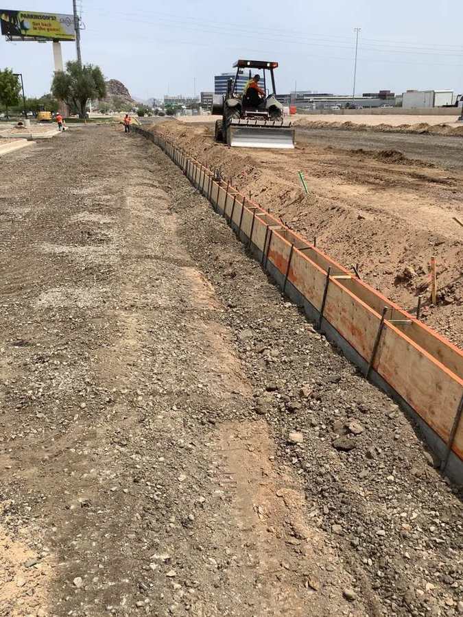 Curb forms set while the dozer fine-grades