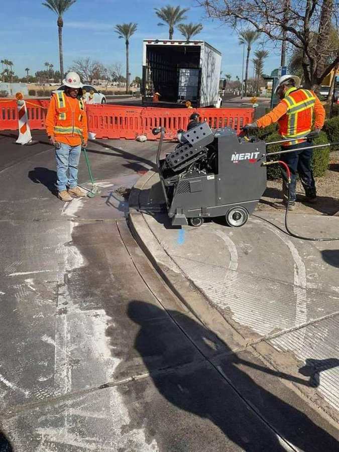 Crew sawcutting a curb radius for an ADA ramp