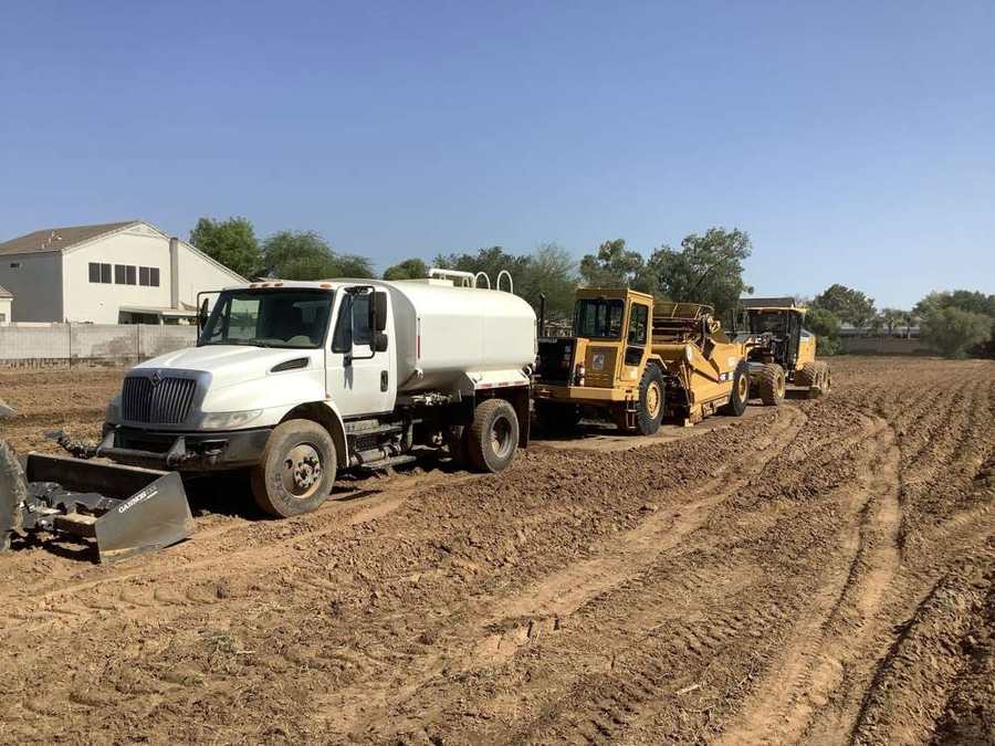Mass grading with a scraper and water truck