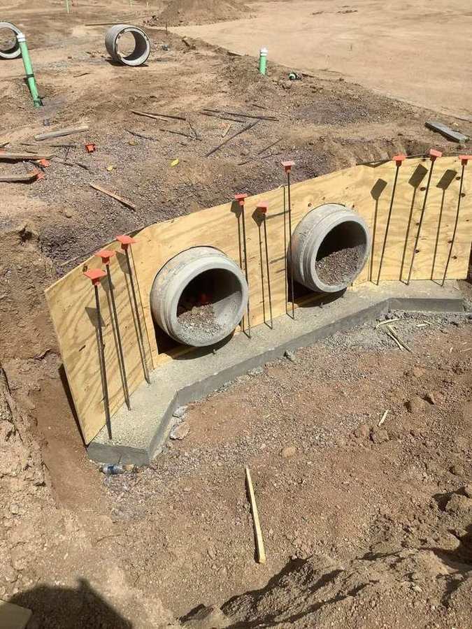 Twin-pipe headwall formed and doweled