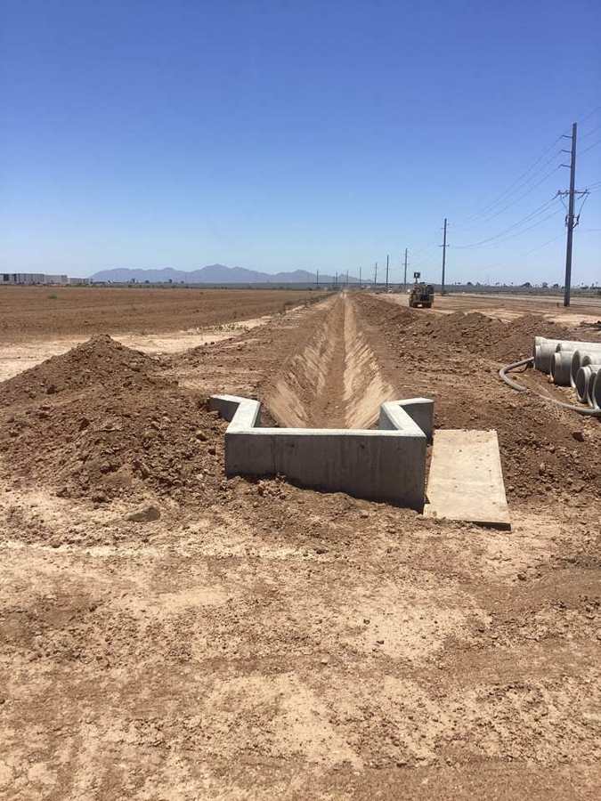 Concrete irrigation turnout at the head of a new ditch