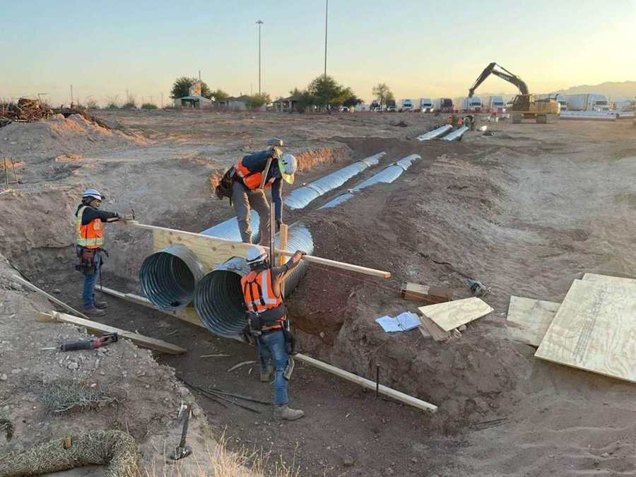 Crew joining storm pipe sections