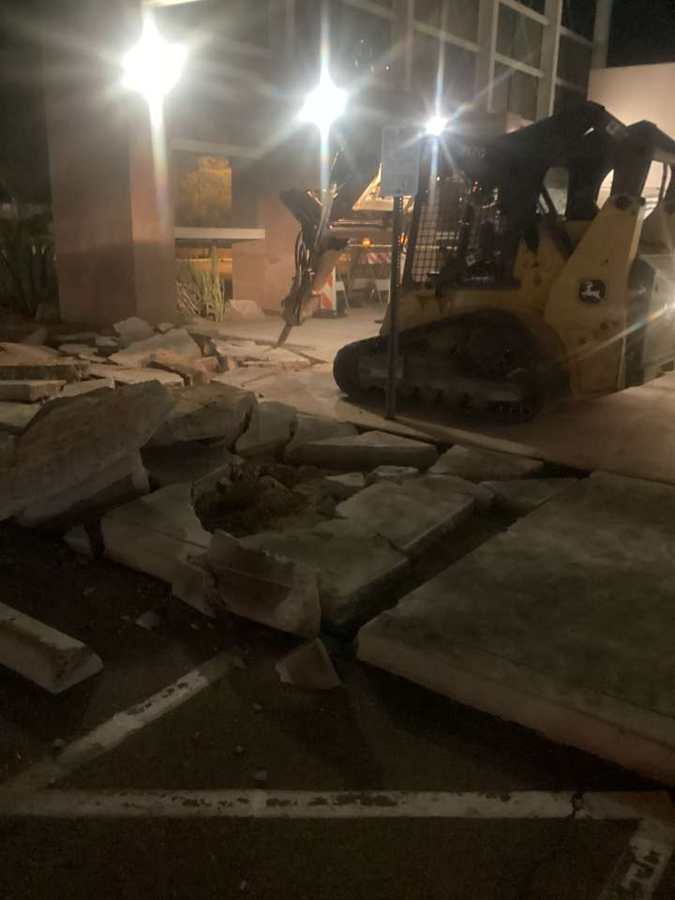 Night sidewalk demo with a hydraulic breaker