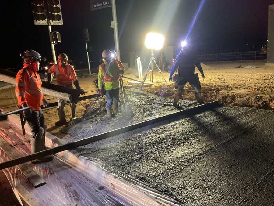Night pour crew screeding concrete