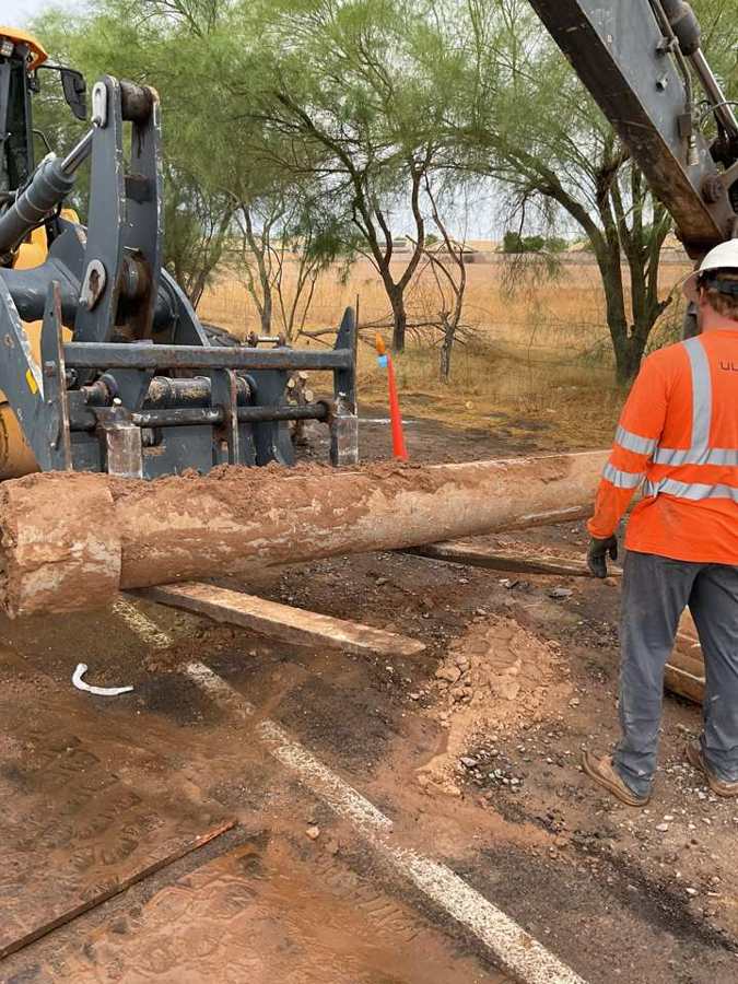 Setting pipe with a loader