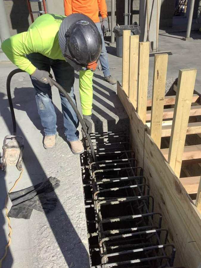 Vibrating concrete in a new channel wall
