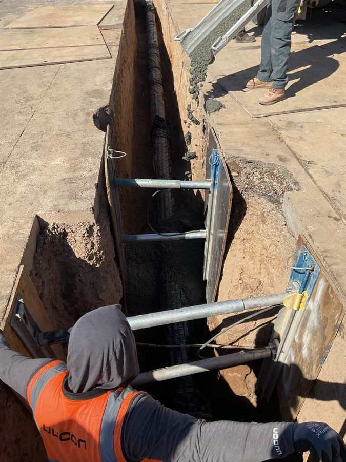 Crew working from the top of a shored trench
