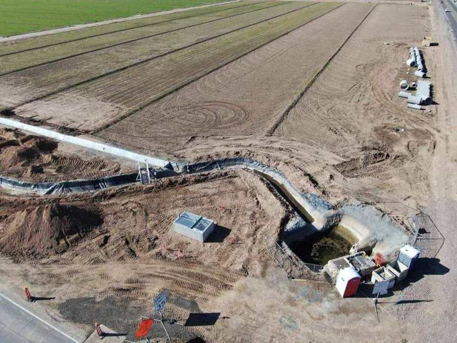 Aerial view of the lined bypass ditch beside farm fields in Avondale