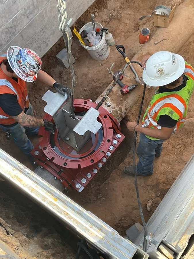 Crew bolting up a tapping valve